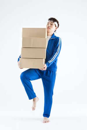 Asian man with boxes isolate on whiteの写真素材