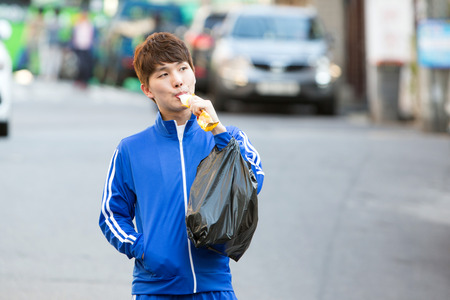 Asian man eating icepop