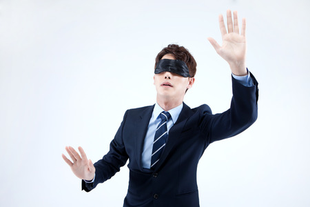 Asian man in suit wearing eye patch isolated on whiteの写真素材