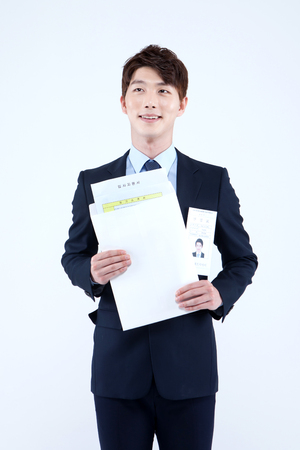 Asian man in suit waiting job interview isolated on whiteの写真素材