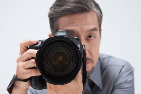 Asian man taking picture isolated on white