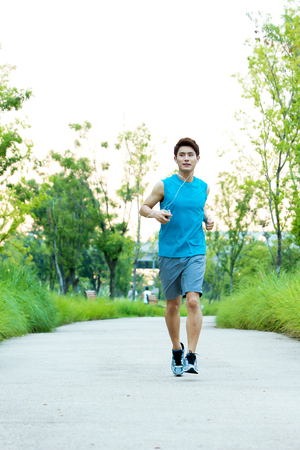 Asian young man jogging outdoorの写真素材