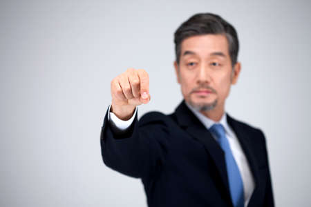 Asian business man pointing isolated on white