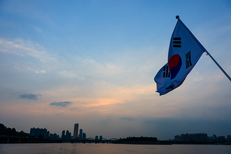 Korean flag blowing in the wind, Hanriver, Seoul, South Koreaの写真素材