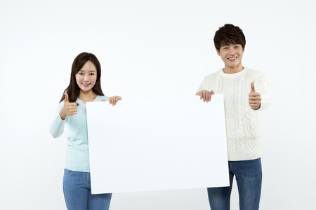 Asian couple with panel isolated on whiteの写真素材
