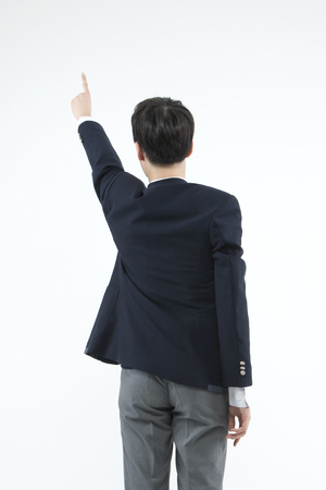 Asian male high school student posing pointing isolated on whiteの写真素材