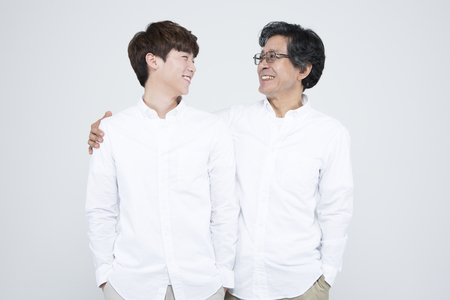 Asian father and son looking happy isolated on whiteの写真素材