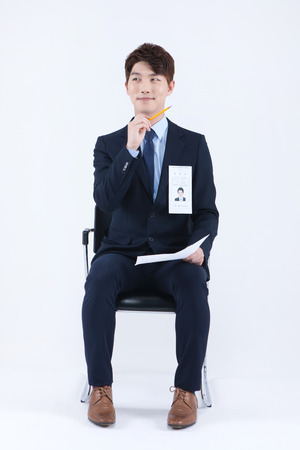 Asian man waiting job interview isolated on whiteの写真素材