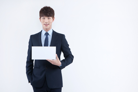 Asian man in suit with panel isolated on whiteの写真素材