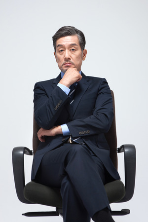 Asian man in suit looking confident isolated on whiteの写真素材