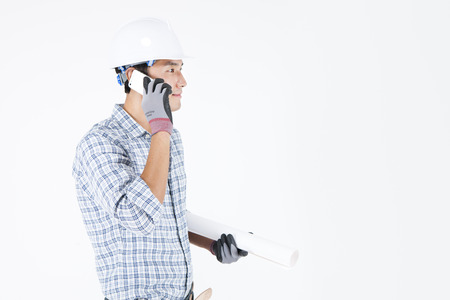 Asian male Engineers in industry helmet with cellphone isolated on white background