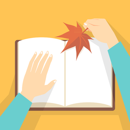 Hand holding maple leaf and bookのイラスト素材
