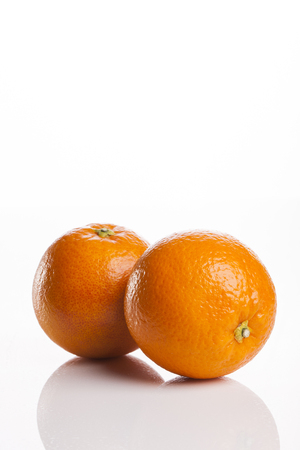 Two ripe oranges isolated on white backgroundの写真素材