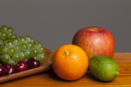 Fresh fruits on a brown table isolated on white backgroundの写真素材
