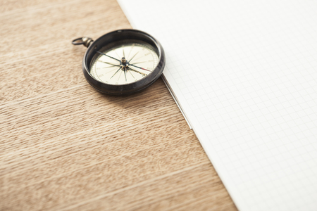 A compass isolated on a paper holderの写真素材