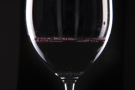 A wine glass isolated on black backgroundの写真素材