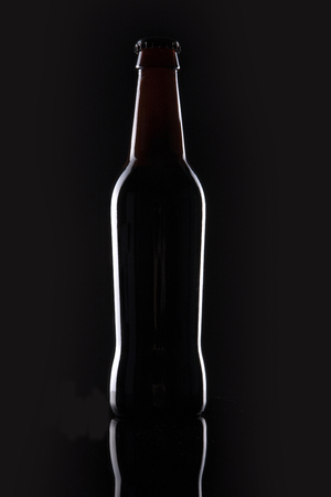 A beer bottle isolated on black backgroundの写真素材