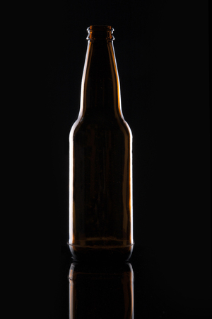 A beer bottle isolated on black backgroundの写真素材
