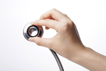 A stethoscope isolated on white background held by a right handの写真素材