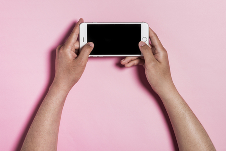 A mobile phone on pink backgroundの写真素材