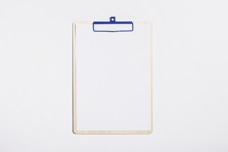 A paper on a wooden paper holder isolated on white backgroundの写真素材