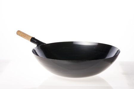 A black steel pan isolated on white backgroundの写真素材