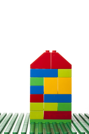 A colorful  building on a green  block isolated on white backgroundの写真素材
