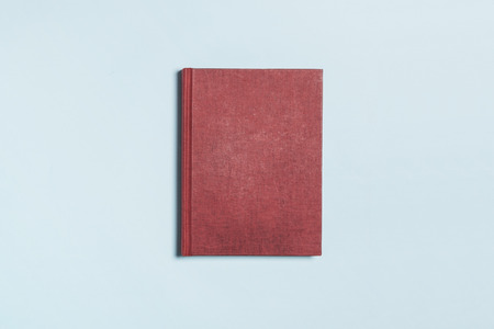 A brown notebook isolated on blue backgroundの写真素材