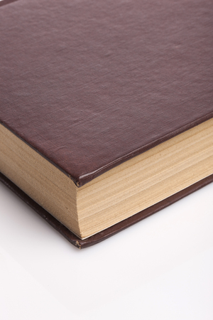 A brown covered book isolated on white backgroundの写真素材