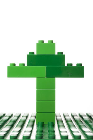 A green tree on a green block isolated on white backgroundの写真素材