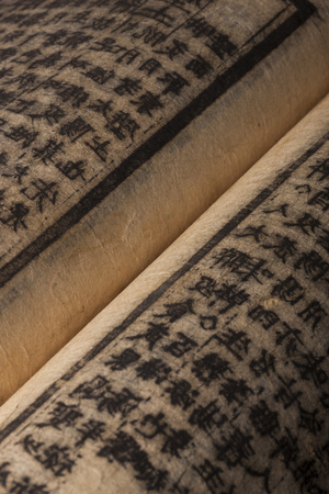 An opened vintage book isolated on white backgroundの写真素材