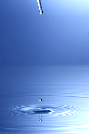 Spread, Water splash at reflective surface.の写真素材