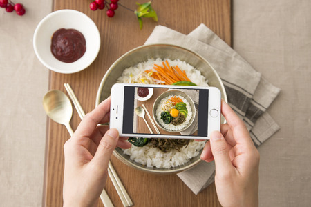 Delicious Korean food - kind of noodles, soup with rice and side dish with fish on the table. 002の写真素材