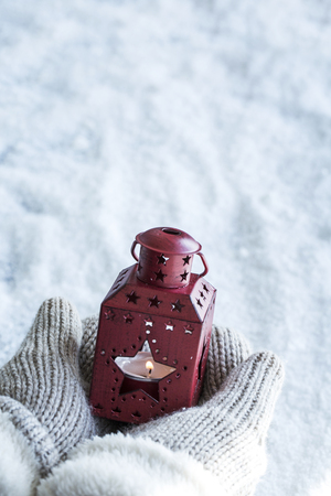 Objects photo for winter season. Hands wearing gloves holding a present.の写真素材