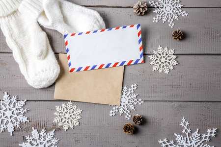 Objects photo for winter season. White socks, envelopes and pinecones on wooden backgroundの写真素材