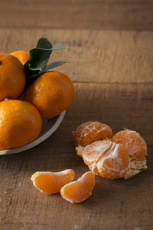 Ripe mandarins isolated on a wooden table backgroundの写真素材
