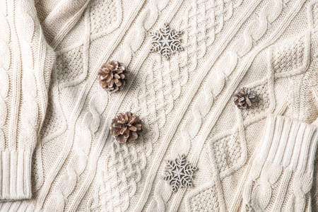 Objects photo for winter season. Pine cones on a sweater