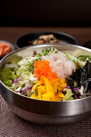 Korean food collection photo_Raw Fish Bibimbap, mixed White rice in bowl top view, raw fish and vegetables 2の写真素材