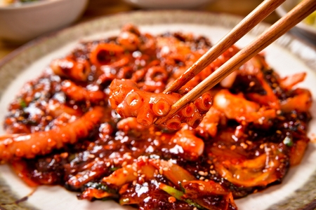 Spicy Korean food small octopus stir-fried, vegetables with spicy sauce