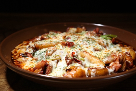Spicy Korean style braised chicken covered in cheese