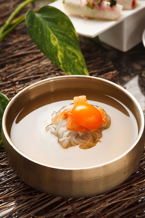 Korean food Cold Noodles with kimchi and sliced tomato, Mul-naengmyeonの写真素材