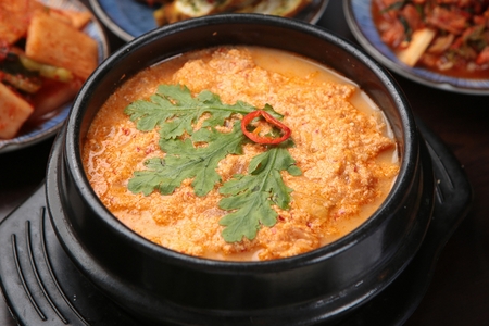 Spicy Korean stew made with bean-curd dregs, kimchi side dishesの写真素材