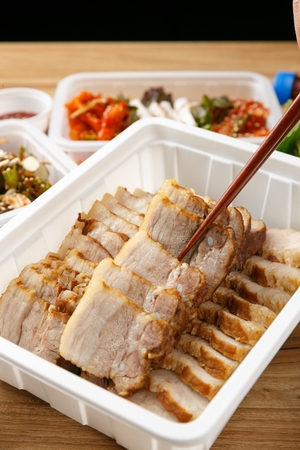 Korean cuisine bossam, thinly spliced boiled pork for take-outの写真素材