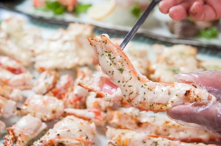 sliced whole king crab, pulling crab meat using chopstick