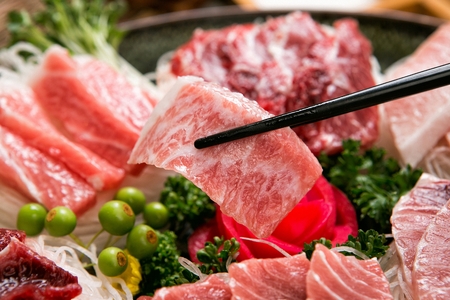 tuna sashimi platter, a piece held by chopsticksの写真素材