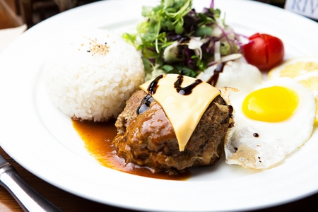 hamburger steak with sunny side up, salad and riceの写真素材
