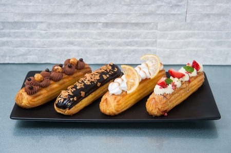 Long cream cake with toppings on topの写真素材