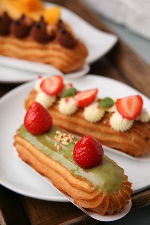 Long cream cake with toppings on top