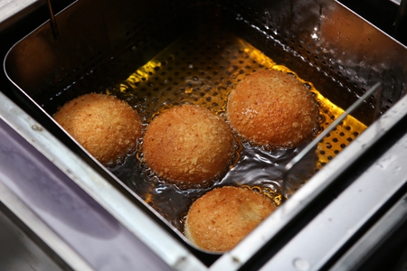 Mashed potatos and stir-fried meat fried into ballsの写真素材