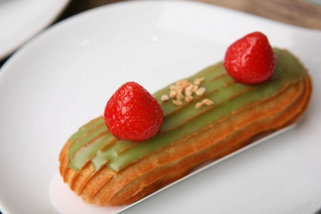 Long cream cake with toppings on top